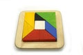 Tangram, Chinese traditional puzzle game made of different colorful wooden pieces that come together in a distinct shape Royalty Free Stock Photo