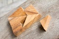 Tangram in heart shape wait for fulfill to complete on wooden ba Royalty Free Stock Photo