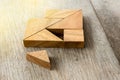 Tangram in heart shape wait for fulfill to complete on wooden ba Royalty Free Stock Photo