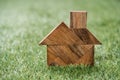 Tangram Puzzle In Home Shape On Green Grass Background