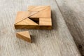 Tangram puzzle wait for fulfill to heart shape on wooden table Royalty Free Stock Photo