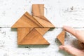 Tangram wait to fulfill home shape on old white wood background conept for build dream home, happy life, house or mortgage