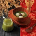 Tangyuan Tang Yuan, Glutinous Dish Dumpling Balls with Sweet Green Tea Syrup Soup in a Bowl on Wooden Table Background for Winter