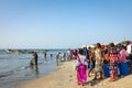 TANJI, THE GAMBIA - NOVEMBER 21, 2019: People carrying fish from the boats to the beach on Tanji, Gambia, West Africa Royalty Free Stock Photo