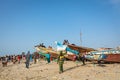 TANJI, THE GAMBIA - NOVEMBER 21, 2019: People carrying fish from the boats to the beach on Tanji, Gambia, West Africa Royalty Free Stock Photo