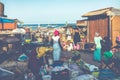 TANJI, THE GAMBIA - NOVEMBER 21, 2019: People carrying fish from the boats to the beach on Tanji, Gambia, West Africa Royalty Free Stock Photo