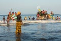 TANJI, THE GAMBIA - NOVEMBER 21, 2019: Scene with men and women carrying fish from the boats to the beach on Tanji, Gambia, West