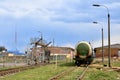 Tank car LNG by rail on oil storage tanks in fuel terminal.  Discharge of liquefied petroleum gas, gasoline Royalty Free Stock Photo