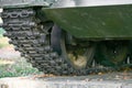 Tank caterpillars close-up. Iron caterpillars of the military heavy tank. Iron caterpillars and wheels of the military heavy tank