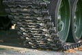 Tank caterpillars close-up. Iron caterpillars of the military heavy tank. Iron caterpillars and wheels of the military heavy tank