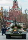 Tank covered by flowers on background of Moscow Kremlin. Unusual decorative elements on the Moscow street.
