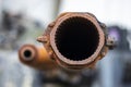 Tank gun, barrel muzzle of a military army close-up. Broken burnt tank. Barrel of a tank gun, selective focus. Destroyed and