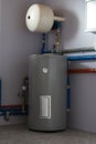 Tank for indirect heating of boiler, expansion tank, boiler piping and meters in boiler room of private house. Vertical