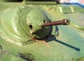 Tank machine gun against the background of the green tank body. Close-up. Blurred background