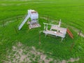 Equipment of an oil well. A tank with methanol near the oil well. Shutoff valves and service equipment Royalty Free Stock Photo