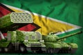 Guyana heavy military armored vehicles concept on the national flag background. 3d Illustration