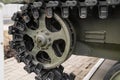 Tank tracks. Tank of the Second World War. Track armor close-up. Black track link and large rubberized rollers. Tank chassis. The Royalty Free Stock Photo