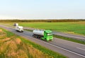 Tank transport of liquid, foodstuff. Metal chrome cistern tanker for food transportation on highway on sunset background. Soft