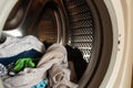 Tank in the washing machine of clean children`s clothes after washing