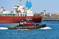 A tanker docked at the IMTT Bayonne Terminal on the Kill Van Kull in Bayonne, NJ. In the foreground is a tug