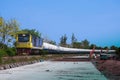 Tanker-freight train by diesel locomotive passed the railway curve.