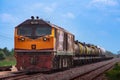 Tanker-freight train by diesel locomotive on the railway.