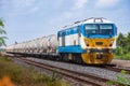 Tanker-freight train by diesel locomotive on the railway.