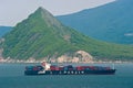 Tanker raid bunker on the container ship Hanjin company against the background of a pointed top. Nakhodka Bay. East (Japan) Sea. Royalty Free Stock Photo