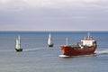 A tanker and sailing ships
