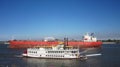 Tanker ship passing the Creole Queen on the Mississippi River in New Orleans Royalty Free Stock Photo