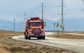 Tanker or Tank Truck on a road with Rocky Mountains silhouette on the background