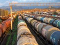 Tanks with fuel on the railway tracks at sunset. Sunset at the train station. Royalty Free Stock Photo