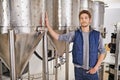These tanks a holding the finest of beers. Portrait of a man working in a microbrewery. Royalty Free Stock Photo