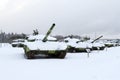 tanks on tracks and other various military equipment in the snow