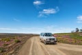 Road landscape with wild flowers and vehicle near Gannaga Lodge