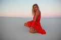 Tanned beautiful girl on the beach on the sands