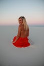 Tanned beautiful girl on the beach on the sands