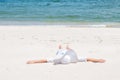 Tanned beautiful woman in hat lying on the beach sand Royalty Free Stock Photo