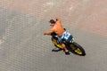 Tanned Biker rides his motor bike on the boardwalk at Virginia Beach, VA