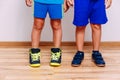 Tanned children`s feet in sports sneakers