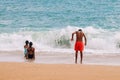 Tanned children in a swimsuit on the beach play on the sand. Atlantic coast, Benagil beach in Portugal