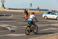 tanned cute caucasian girl in a white t-shirt and shorts on a bicycle