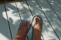 tanned feet in beach flip-flops. summer vacation under the sun. background for the design