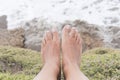 Tanned feet of a girl in a natural environment, on vacation, on the coast