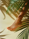 Tanned female leg with smooth skin and orange nail polish on toes. Elegant foot on smooth surface with shadows. Generative AI