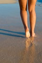 Tanned legs on the beach Royalty Free Stock Photo
