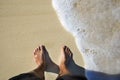 Tanned legs on sand beach Royalty Free Stock Photo