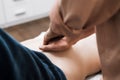 A man does a woman a massage of the abdomen, osteopathy 1 Royalty Free Stock Photo