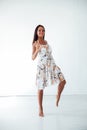 beautiful tanned woman in a summer dress in a white room Royalty Free Stock Photo