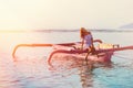 Tanned woman tilted her head while in the boat at sunset. in soft focus